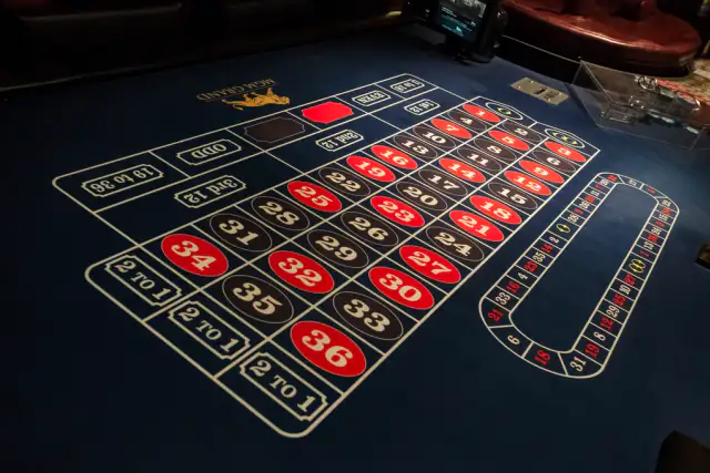 Roulette betting layout with red and black numbers on blue felt